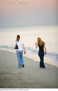two women walking on beach